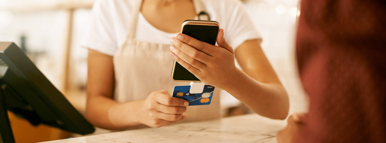 Cafe working swiping card on mobile reader.